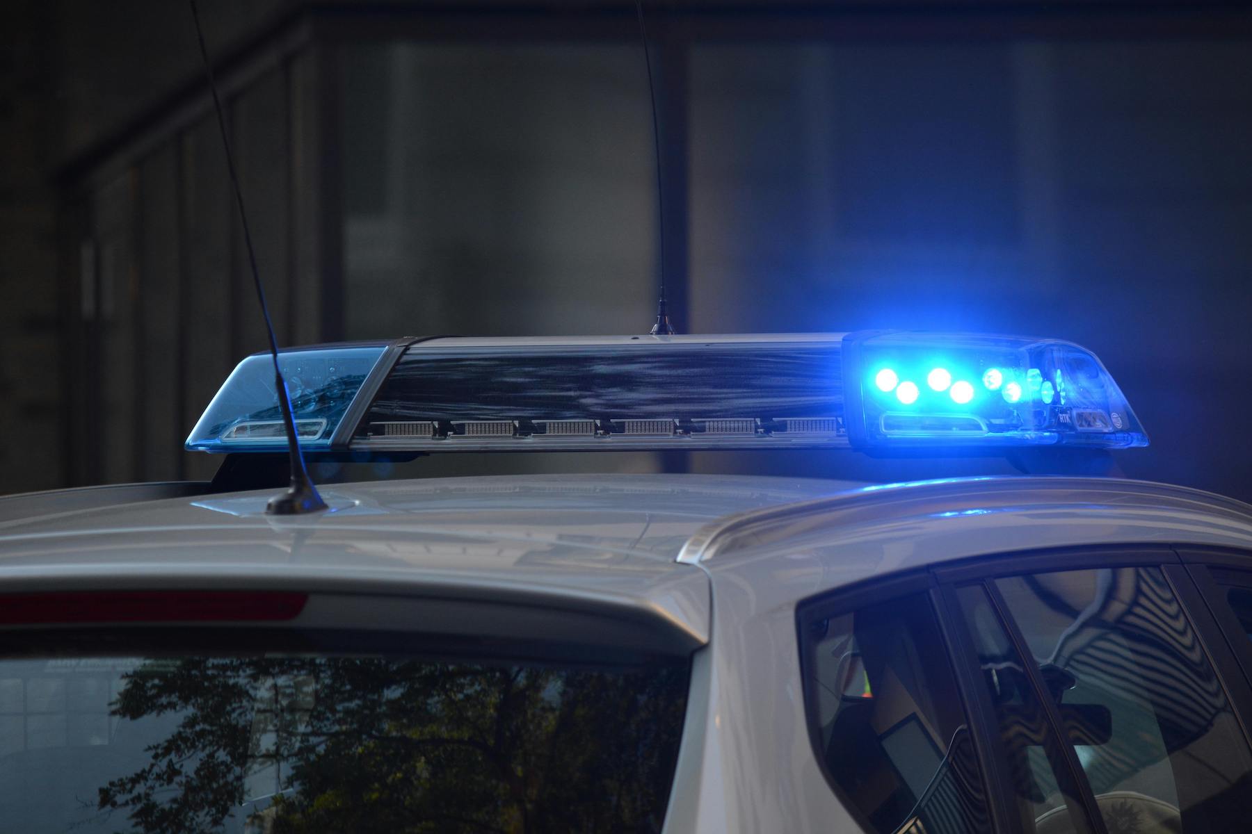 top of a police car with blue lights shining